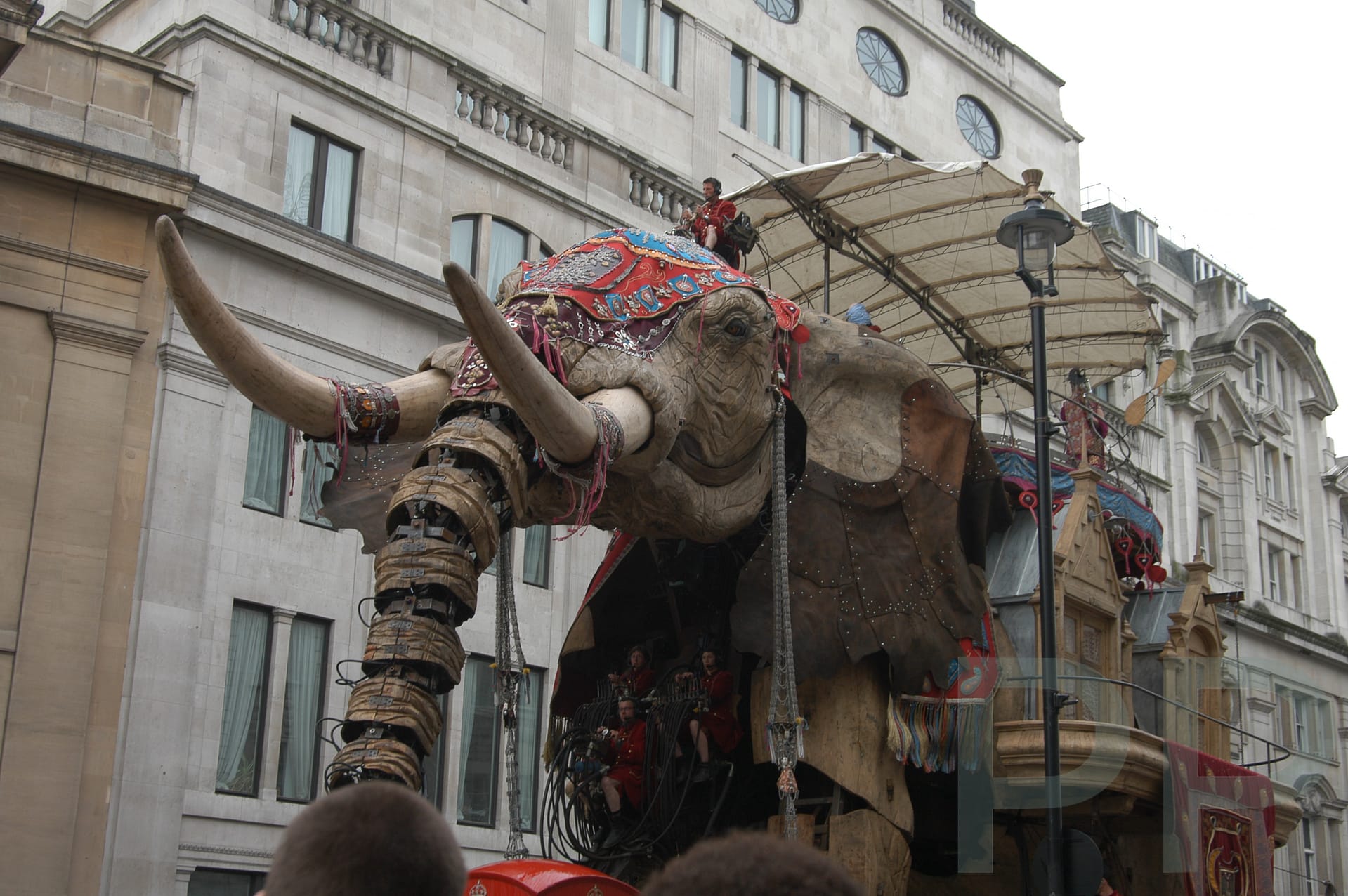 Large mechanical elephant moving through Piccadilly Circus in London during a street event