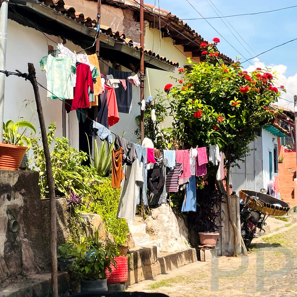 Colorful cobblestone street in Suchitoto, El Salvador, with colonial houses and flowers