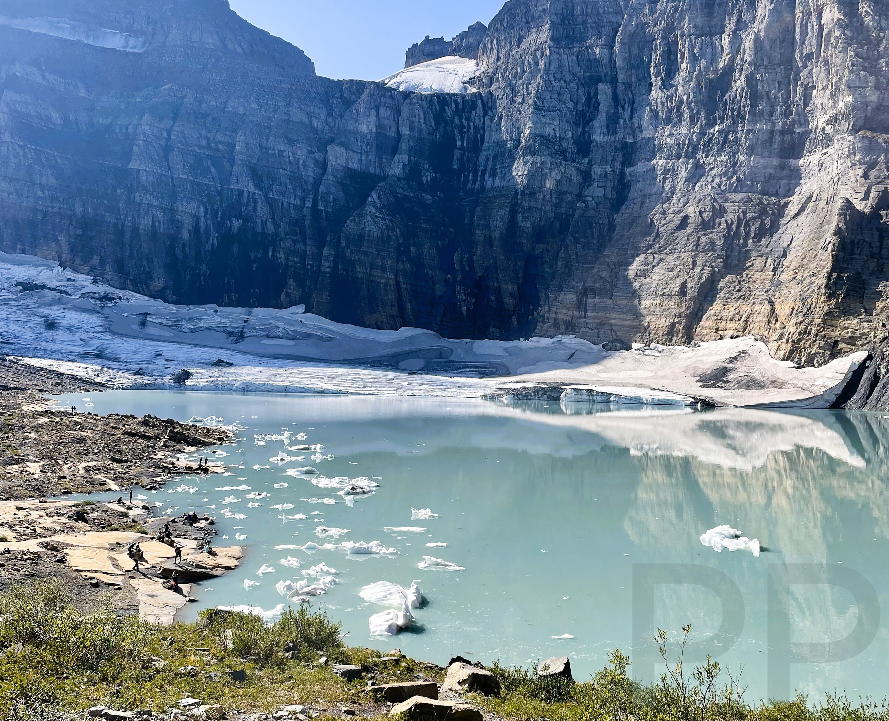 Glacial melt forms a pool at the foot of Grinnell Glacier in Glacier National Park