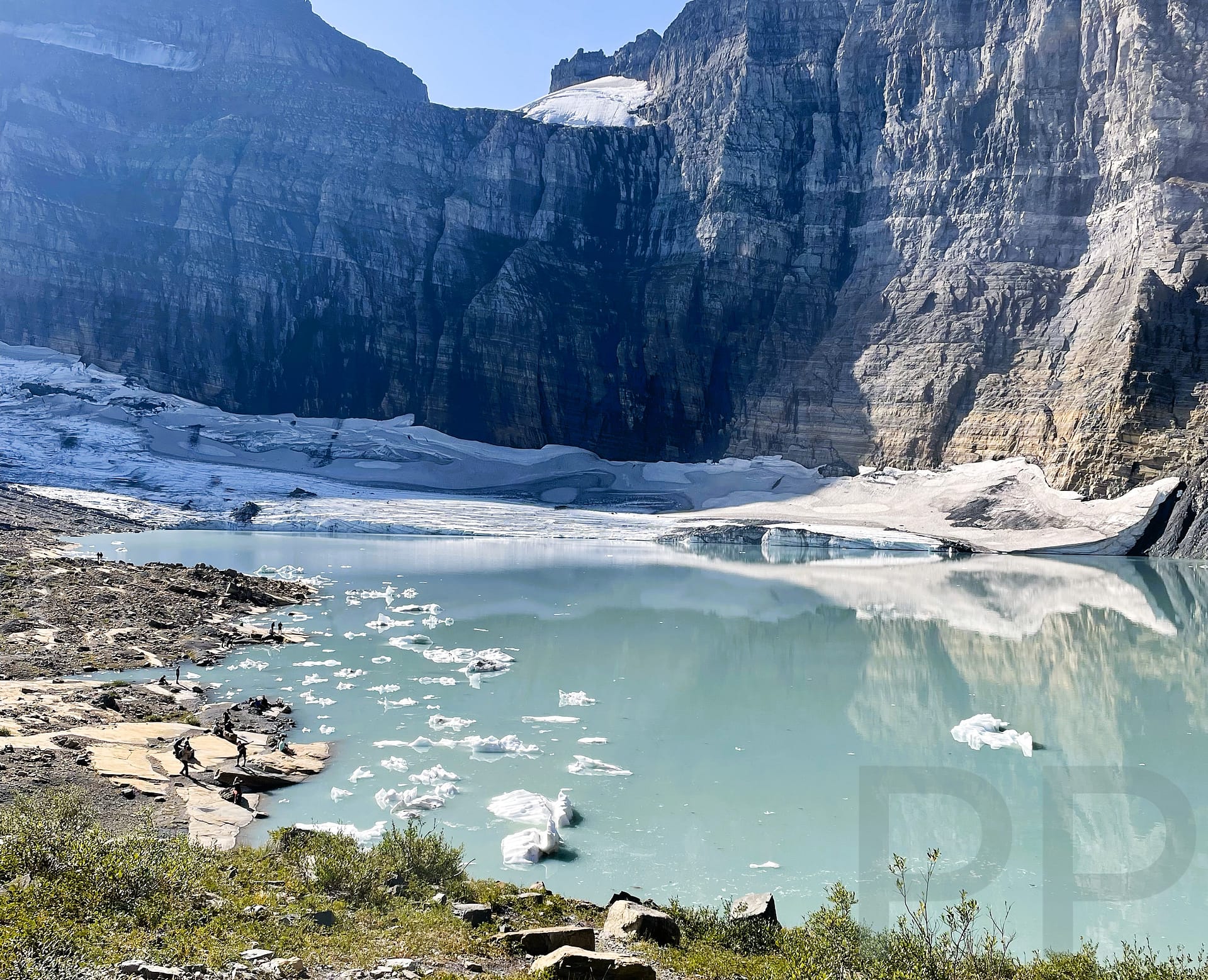 Glacial melt forms a pool at the foot of Grinnell Glacier in Glacier National Park
