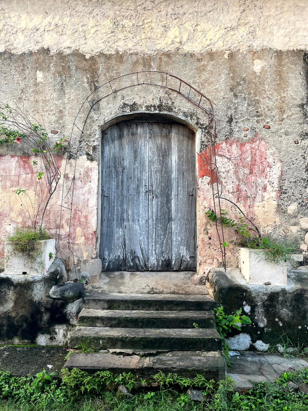 rustic house door in Suchitoto with faded, pastel colors