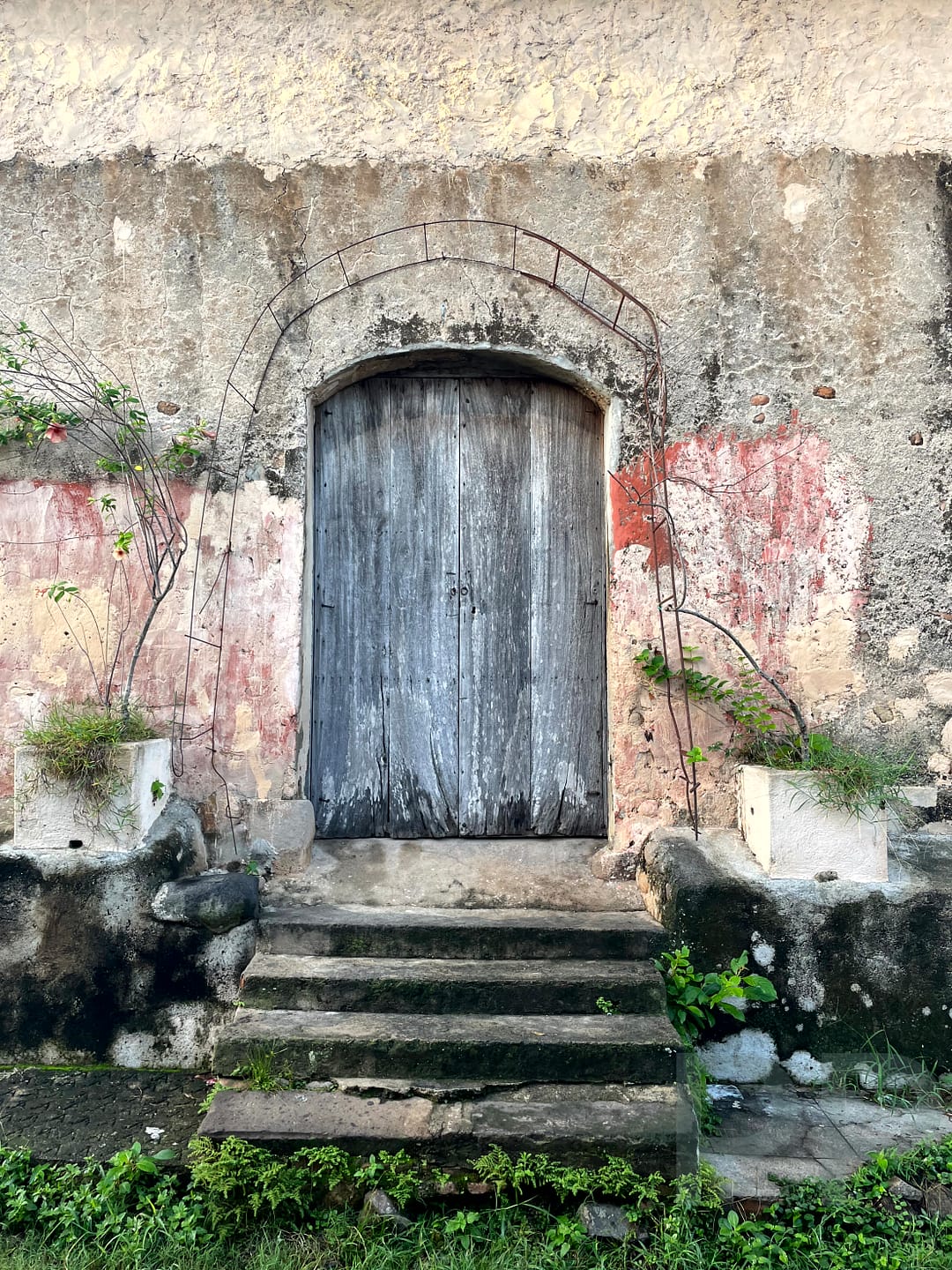 rustic house door in Suchitoto with faded, pastel colors