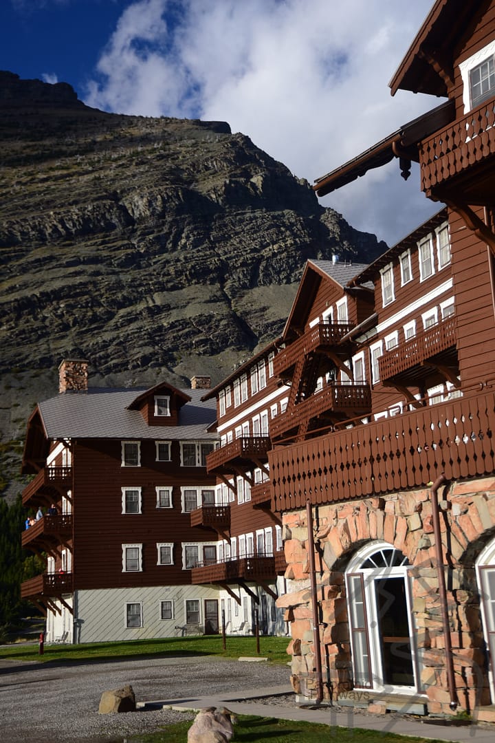 View of back of Many Glacier Hotel, Rooms with balconies, towering mountains, National Park