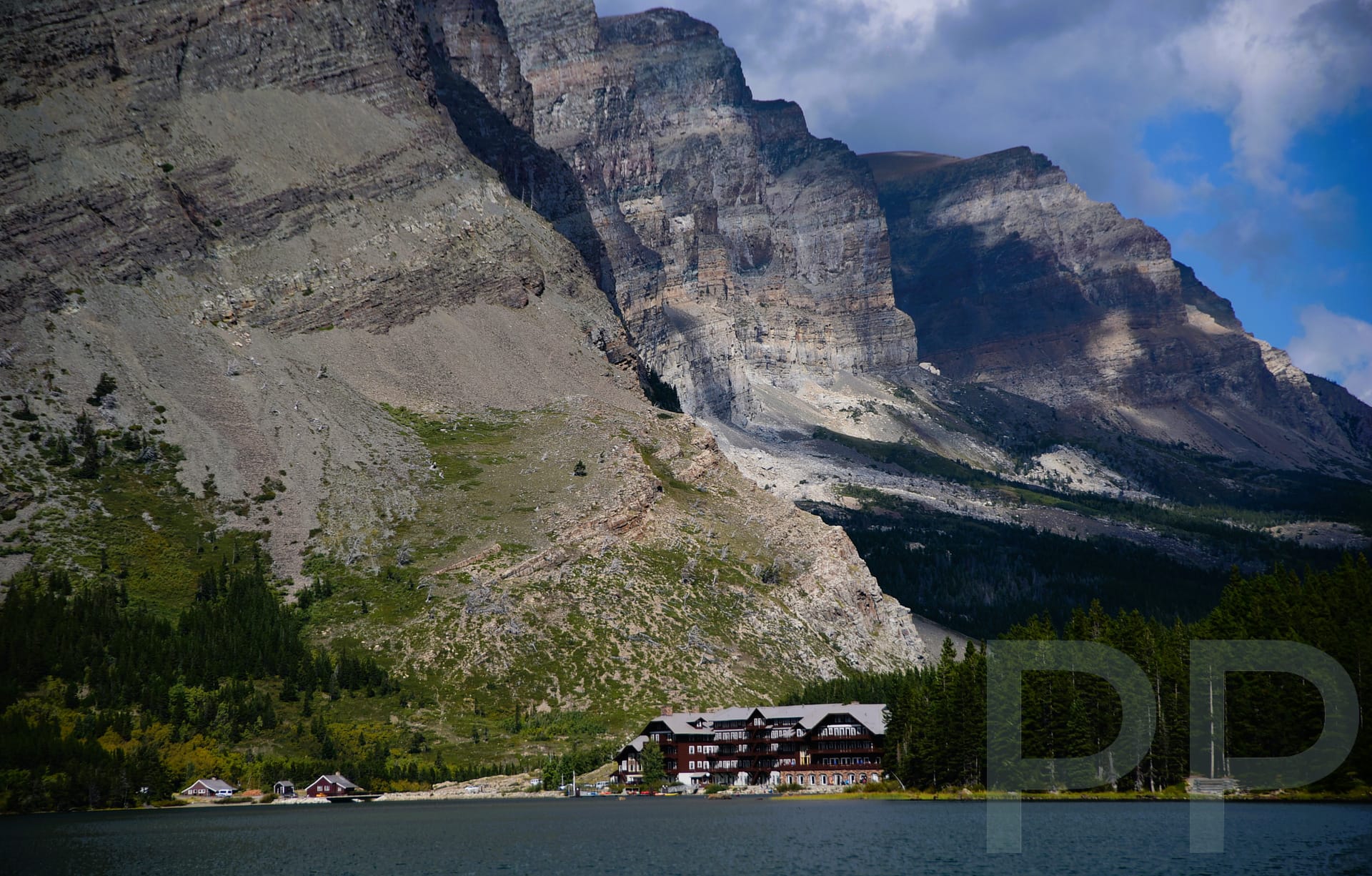 Many Glacier Hotel on Swiftcurrent Lake with dramatic mountain backdrop in Glacier National Park