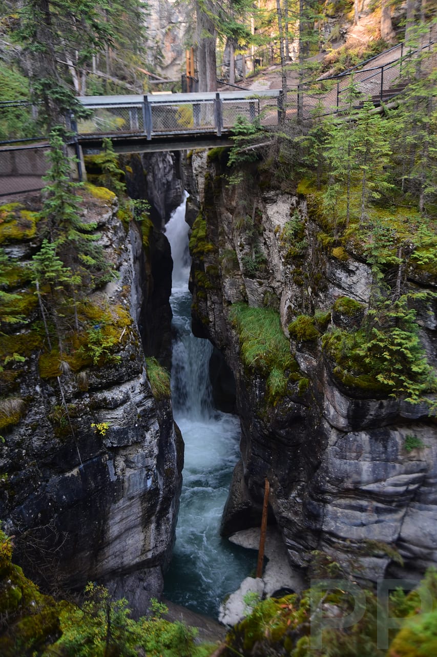 Bridge crossing the rushing river inside Maligne Canyon, Jasper National Park, Alberta.