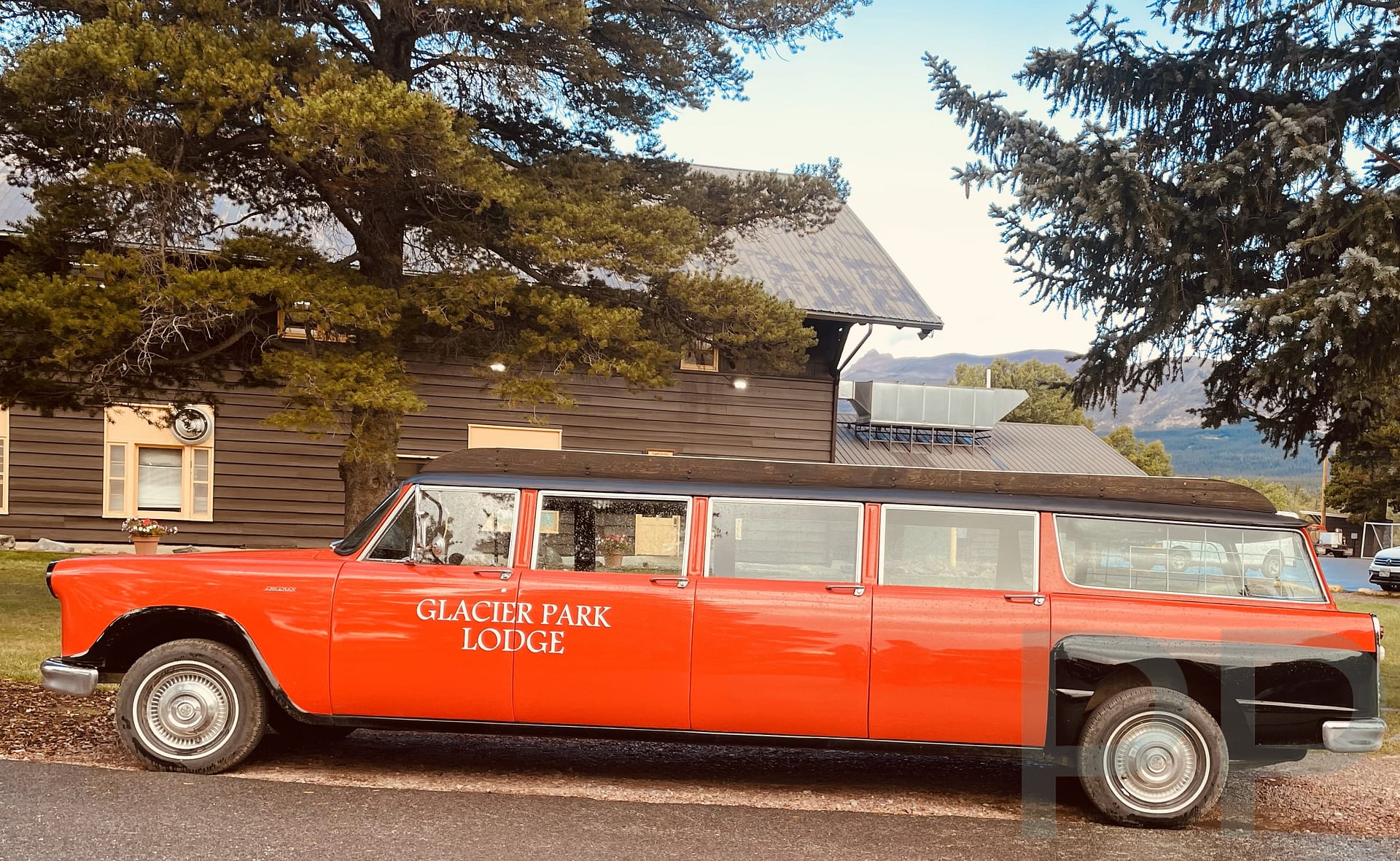 Historic Glacier Park Lodge Red Bus parked outside the lodge in East Glacier, Montana