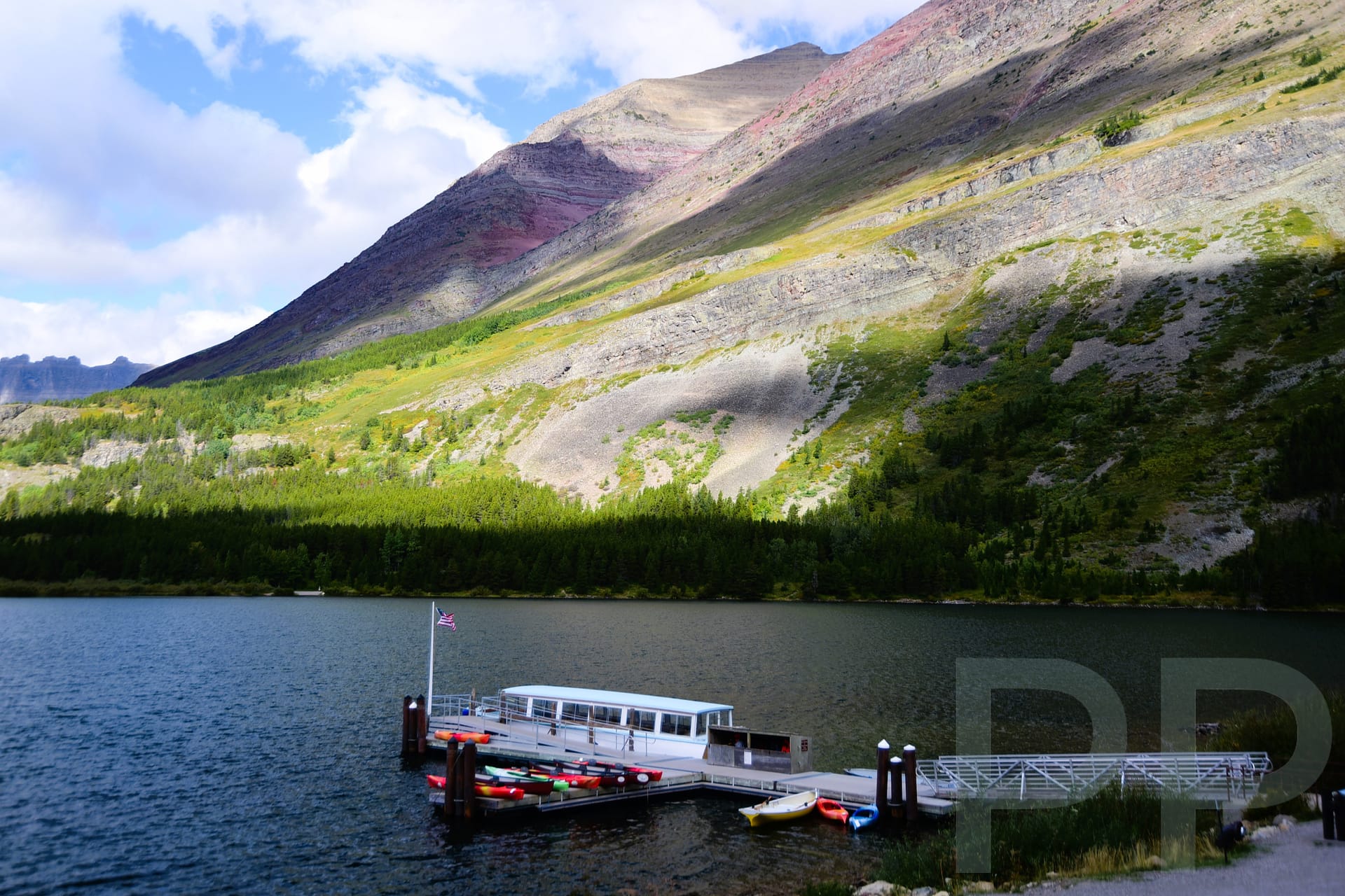 Boat dock on Swiftcurrent Lake behind Many Glacier Hotel used for scenic boat tours in Glacier National Park