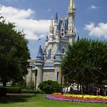 Disney World Castle with blue skies and flowers