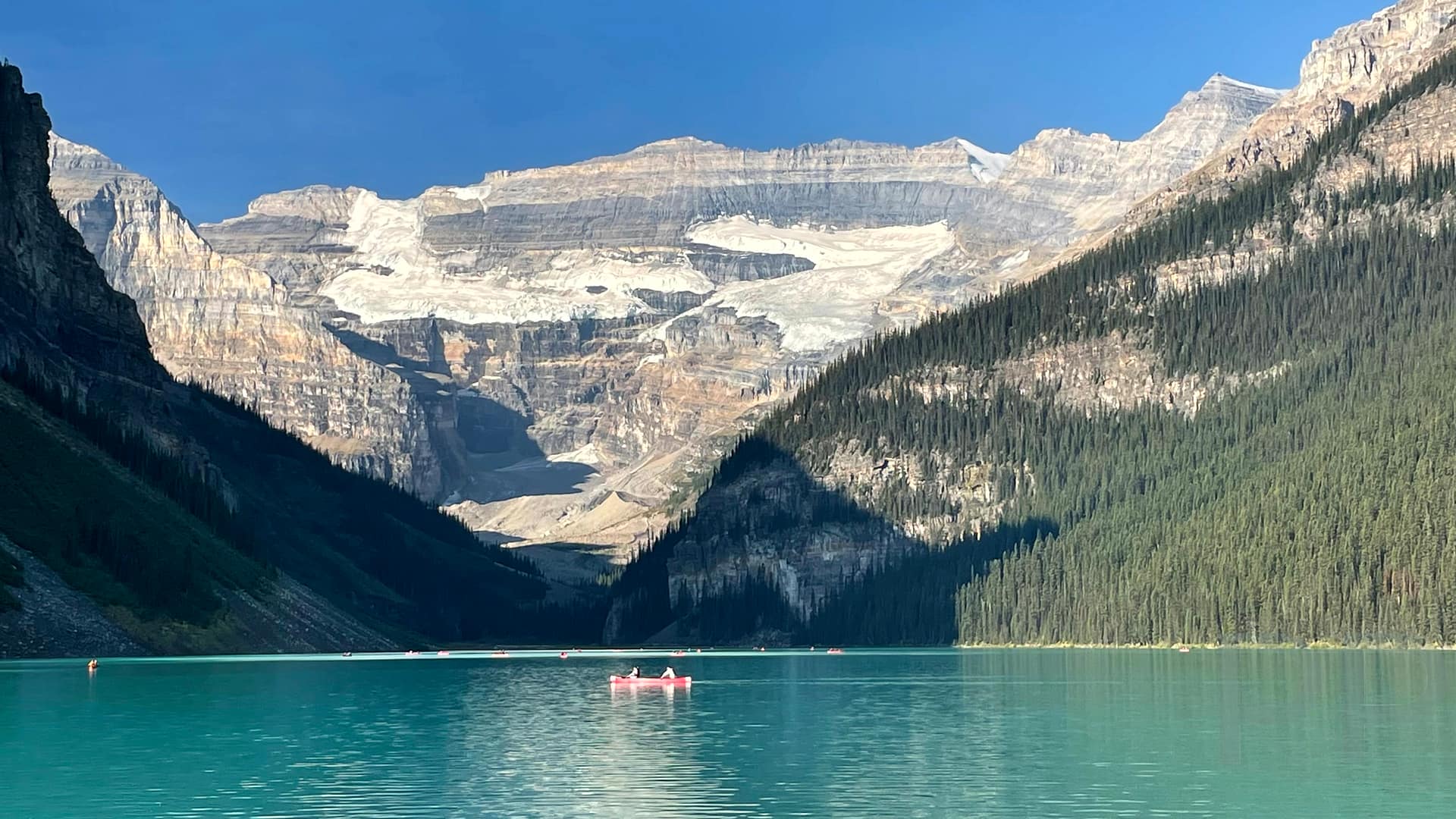Lake Louise View in Banff National Park with Mountains and Canoe in Morning