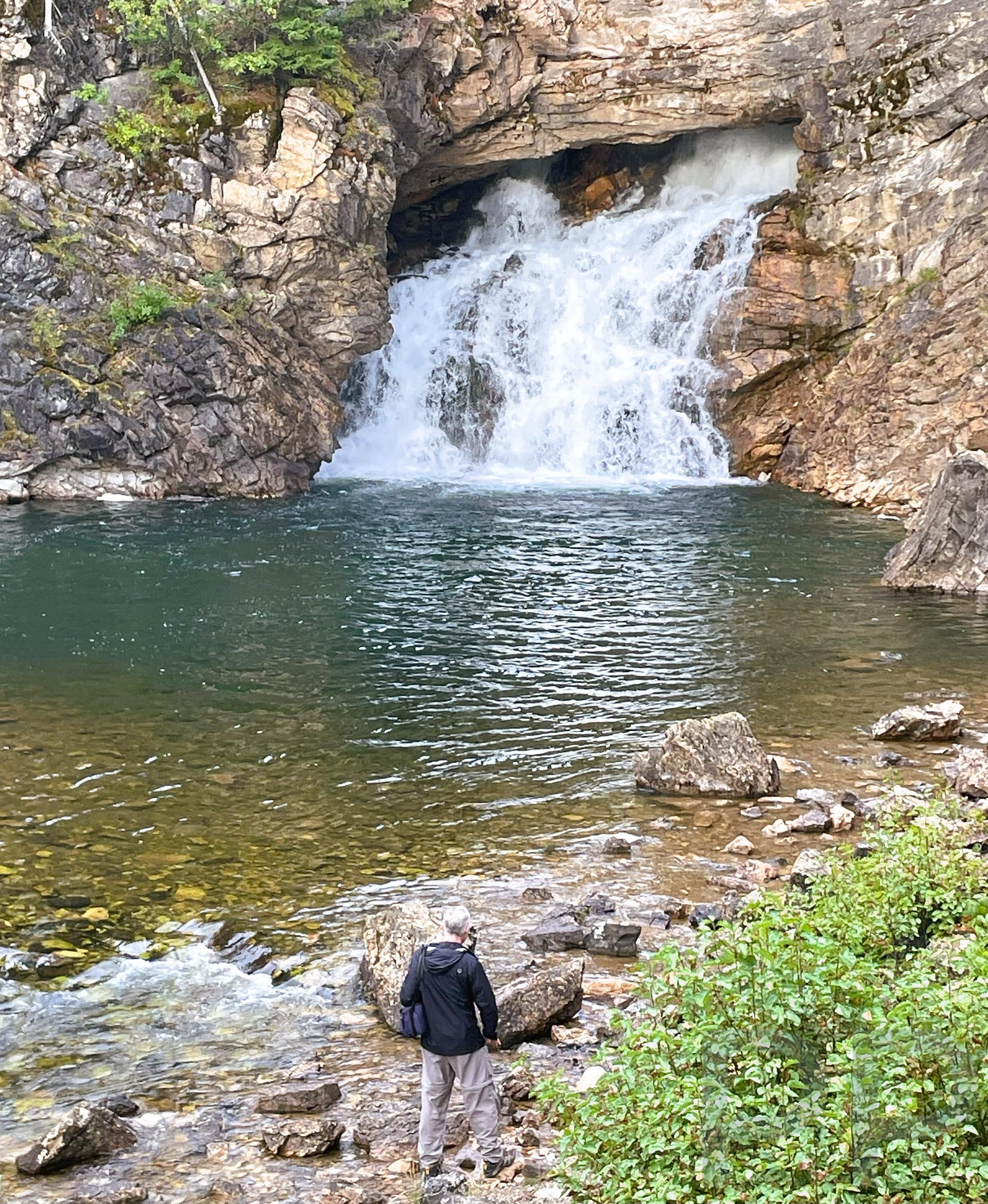 Running Eagle Falls in the Two Medicine area of Glacier National Park with person for scale