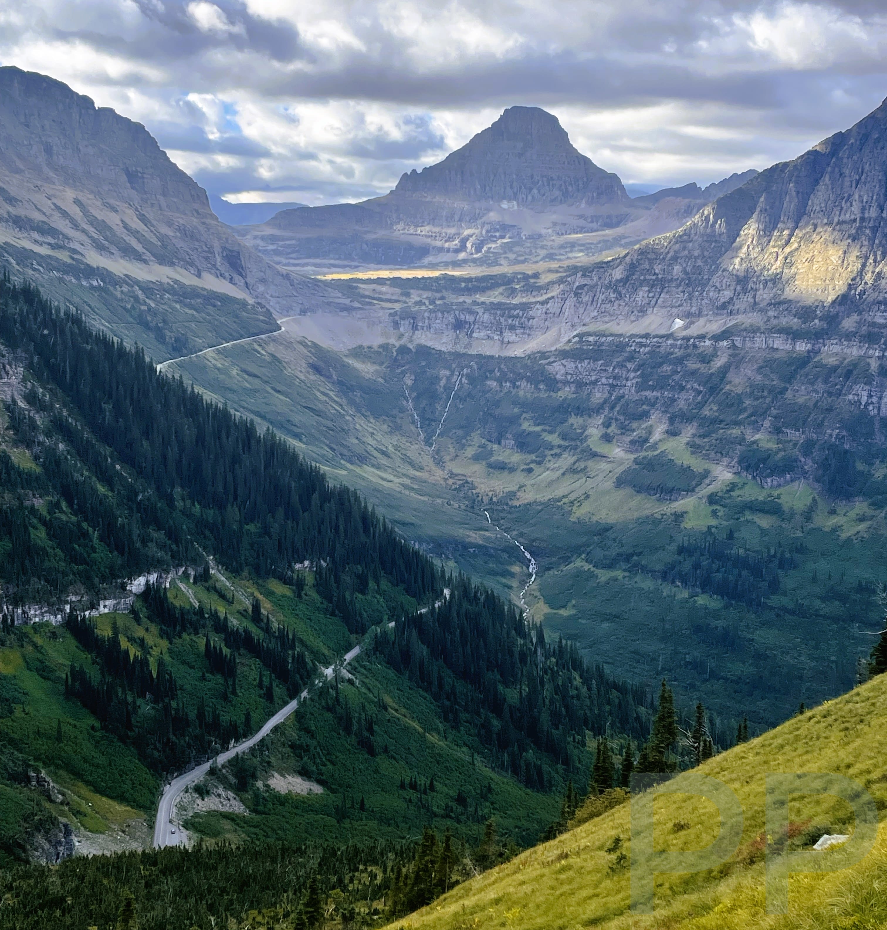 Expansive view from the Highline Trail with the Going-to-the-Sun Road winding through the valley below.