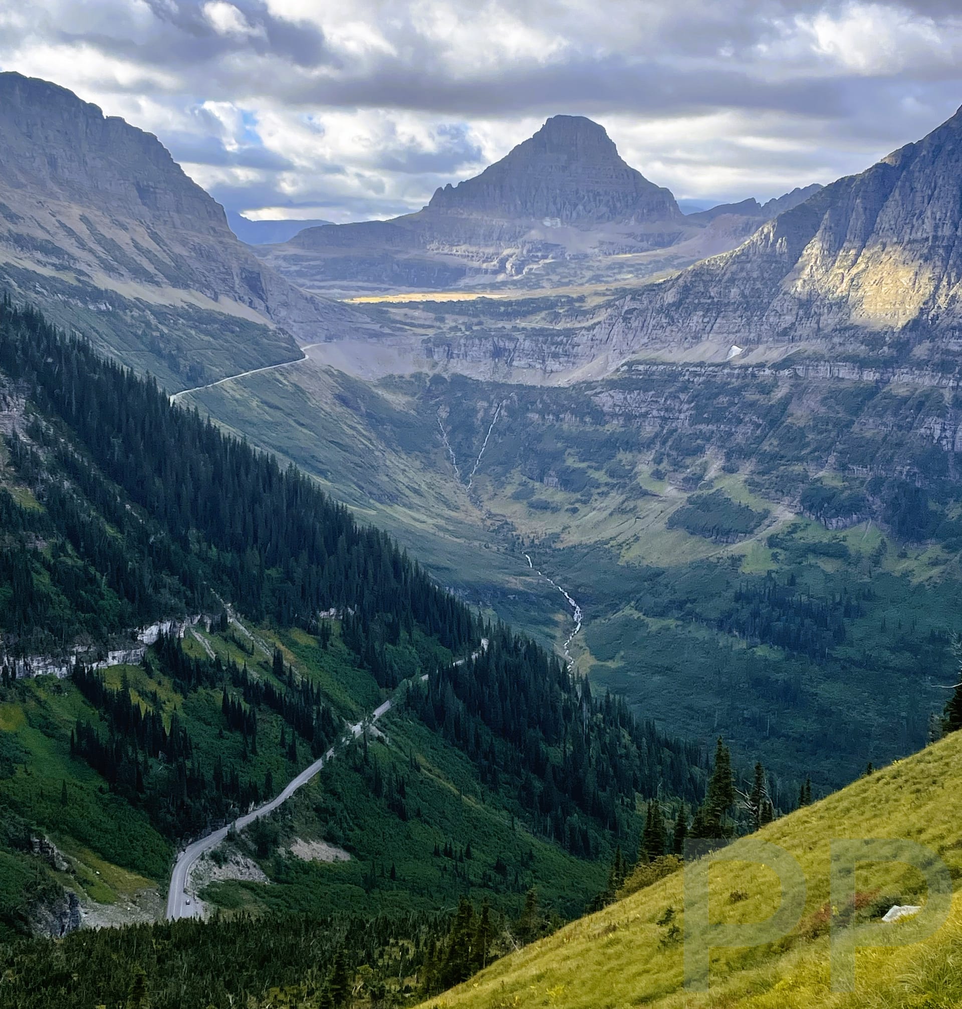 Expansive view from the Highline Trail with the Going-to-the-Sun Road winding through the valley below.