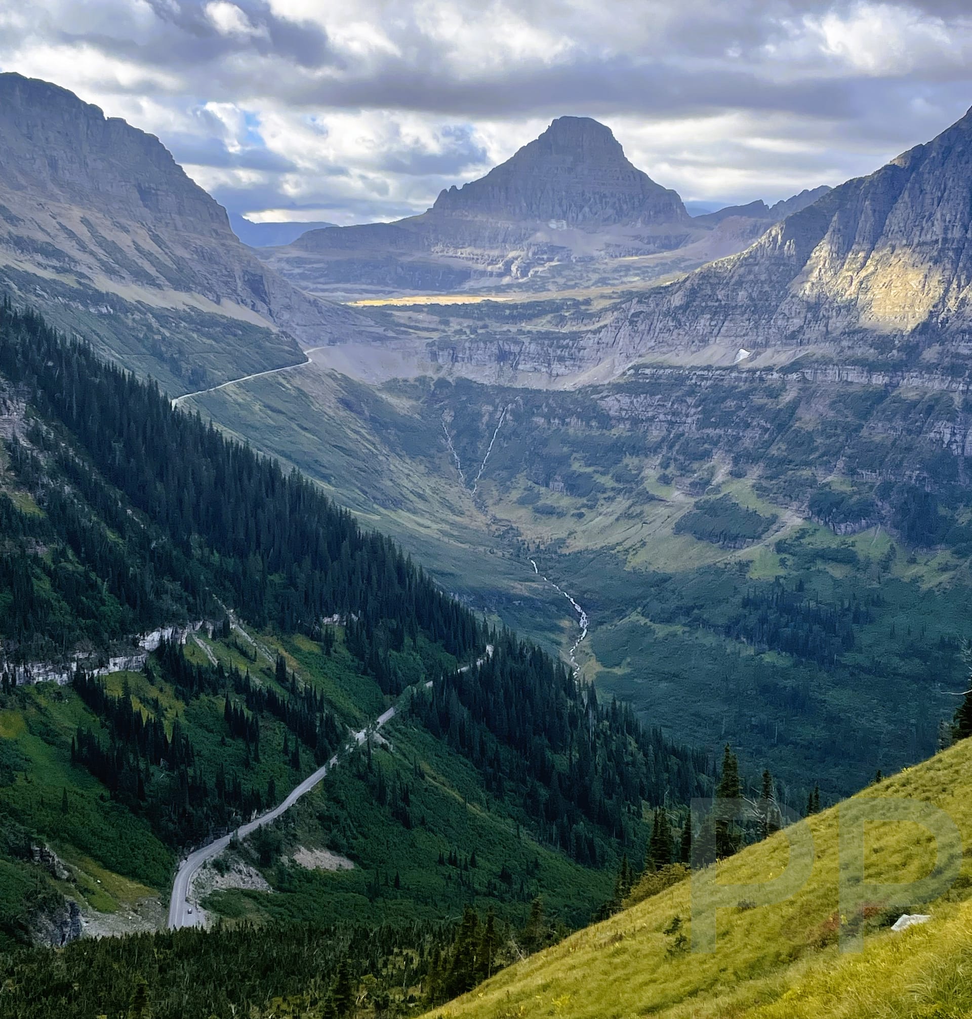 Expansive view from the Highline Trail with the Going-to-the-Sun Road winding through the valley below.