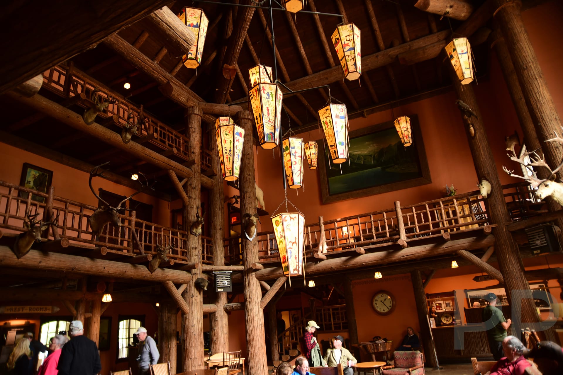 Rustic interior of Lake McDonald Lodge with exposed beams and three-story lobby in Glacier National Park