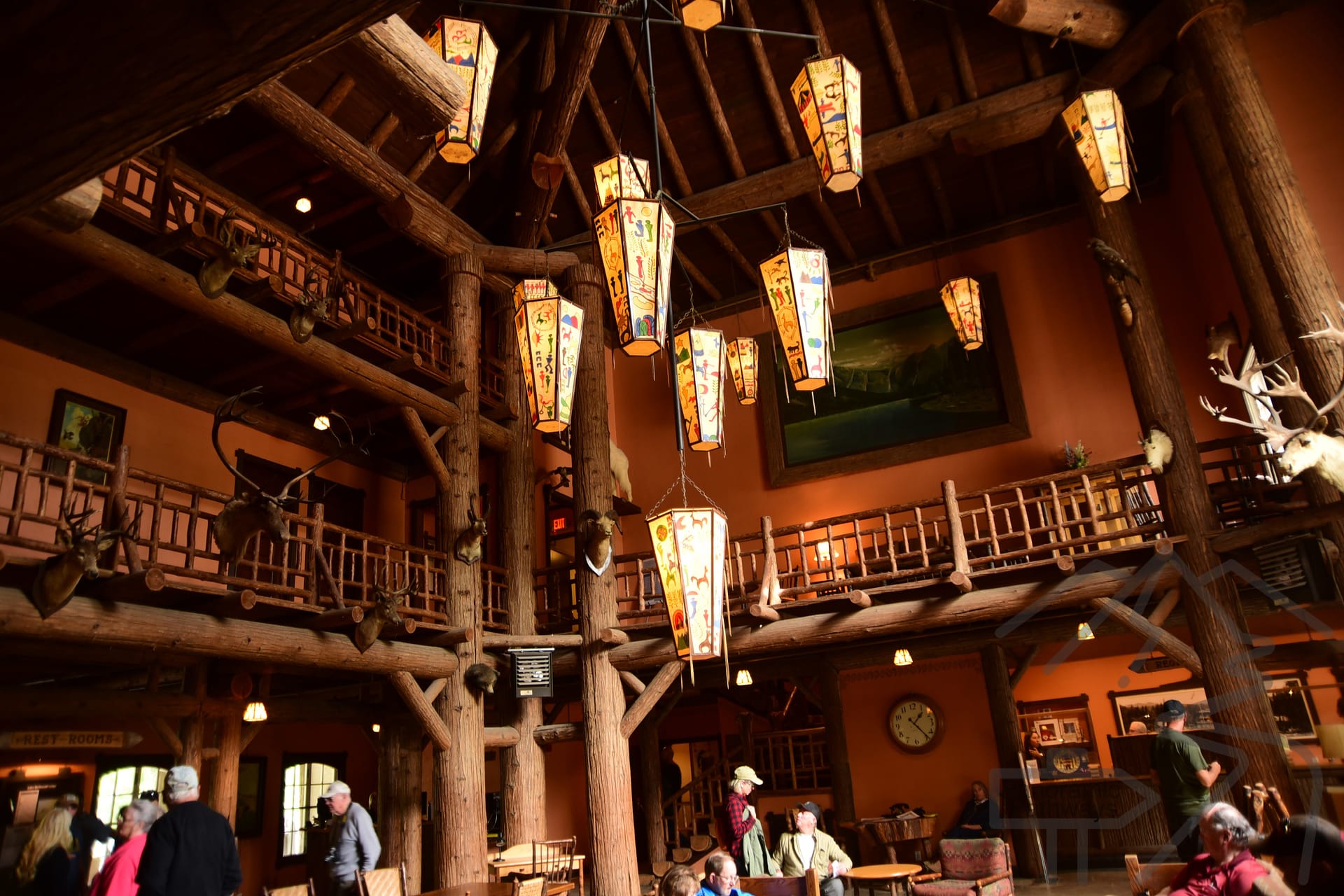 Rustic interior of Lake McDonald Lodge with exposed beams and three-story lobby in Glacier National Park