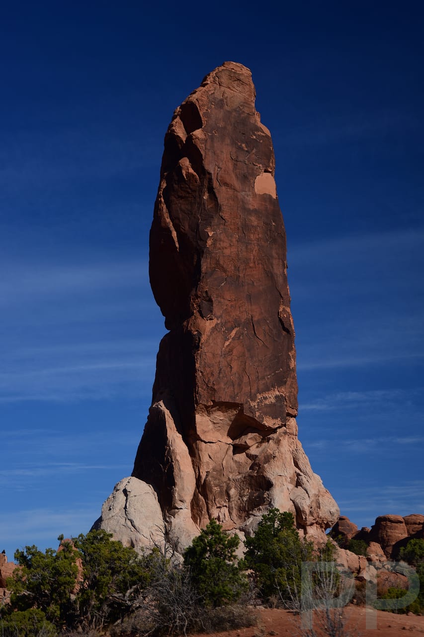 Dark Angel sandstone spire rising above desert in Arches National Park