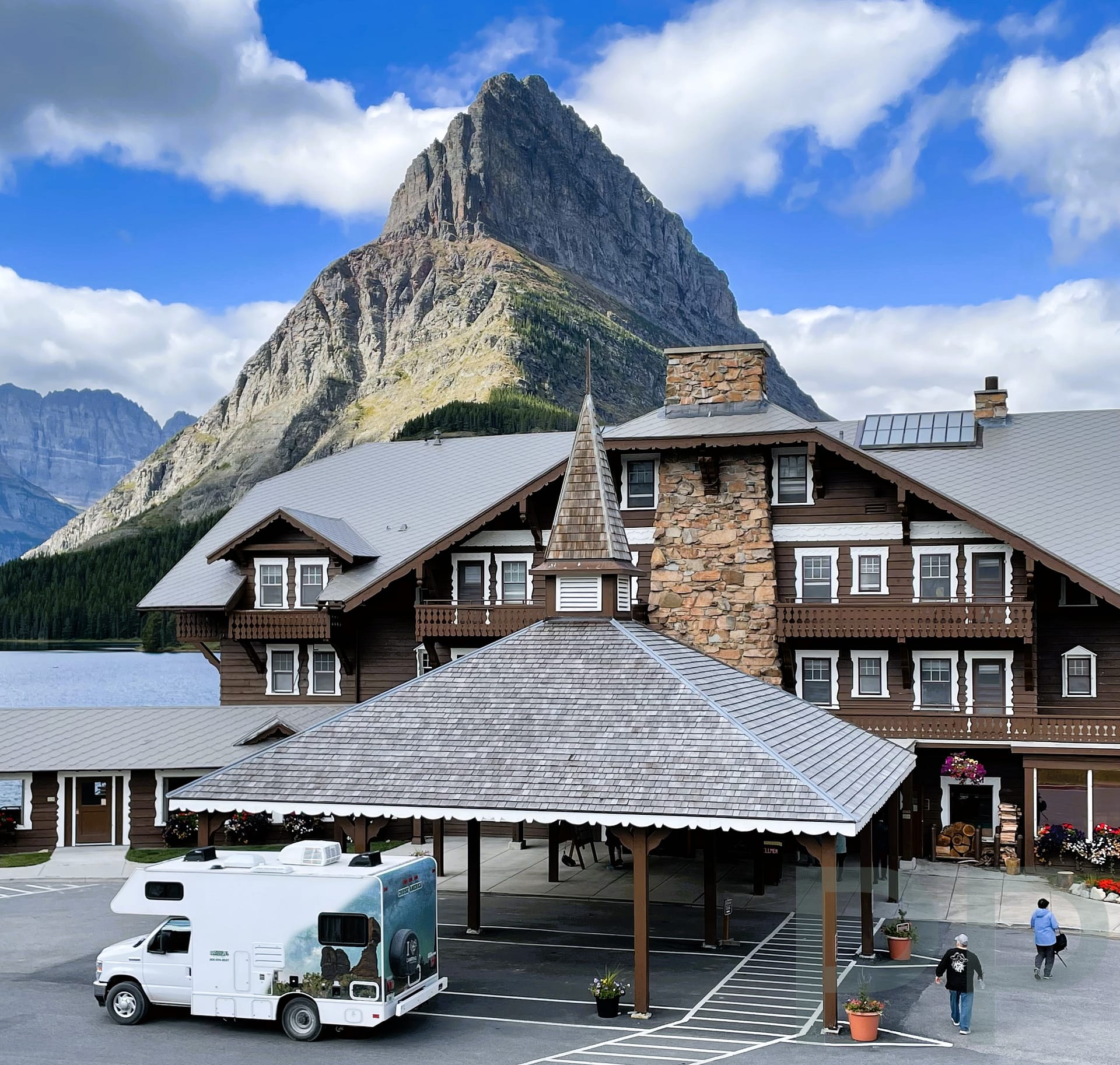 Many Glacier Hotel exterior with Grinnell Point towering above in Glacier National Park