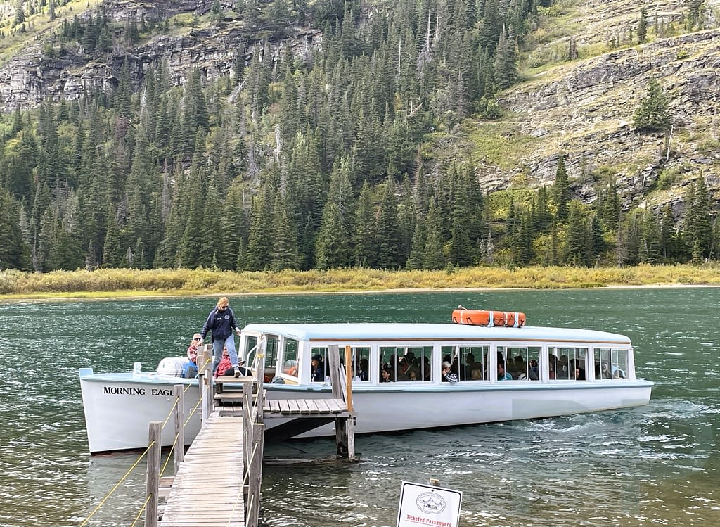 The Morning Eagle boat docking at the Lake Josephine shoreline in Glacier National Park