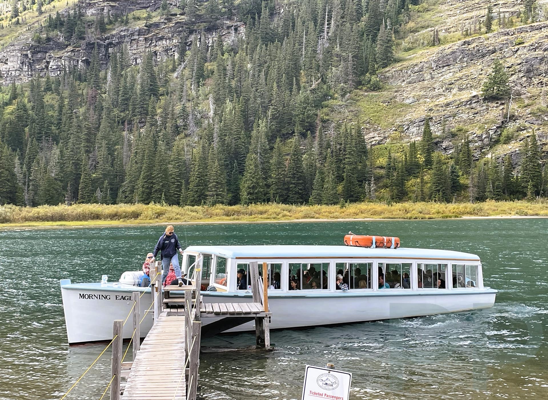 The Morning Eagle boat docking at the Lake Josephine shoreline in Glacier National Park