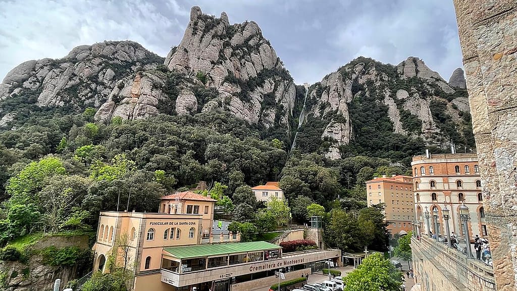 View from Montserrat Monastery down to the Cremallera station with towering rock formations in the background
