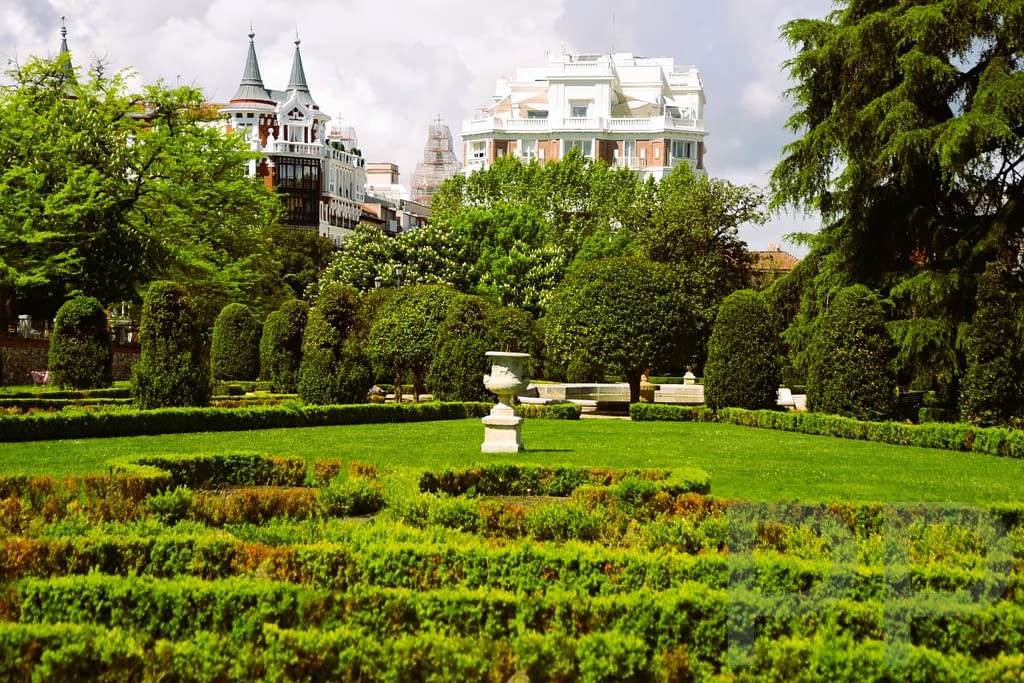 Gardens and tree-lined paths in Retiro Park in Madrid.