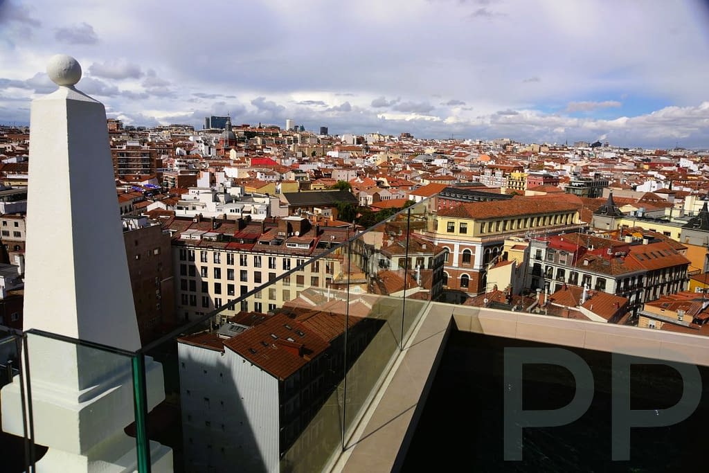 Rooftop view in Madrid looking out over buildings and city streets from a high vantage point.