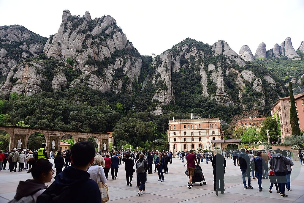 Crowds gathered in the main plaza at Montserrat Monastery in Spain