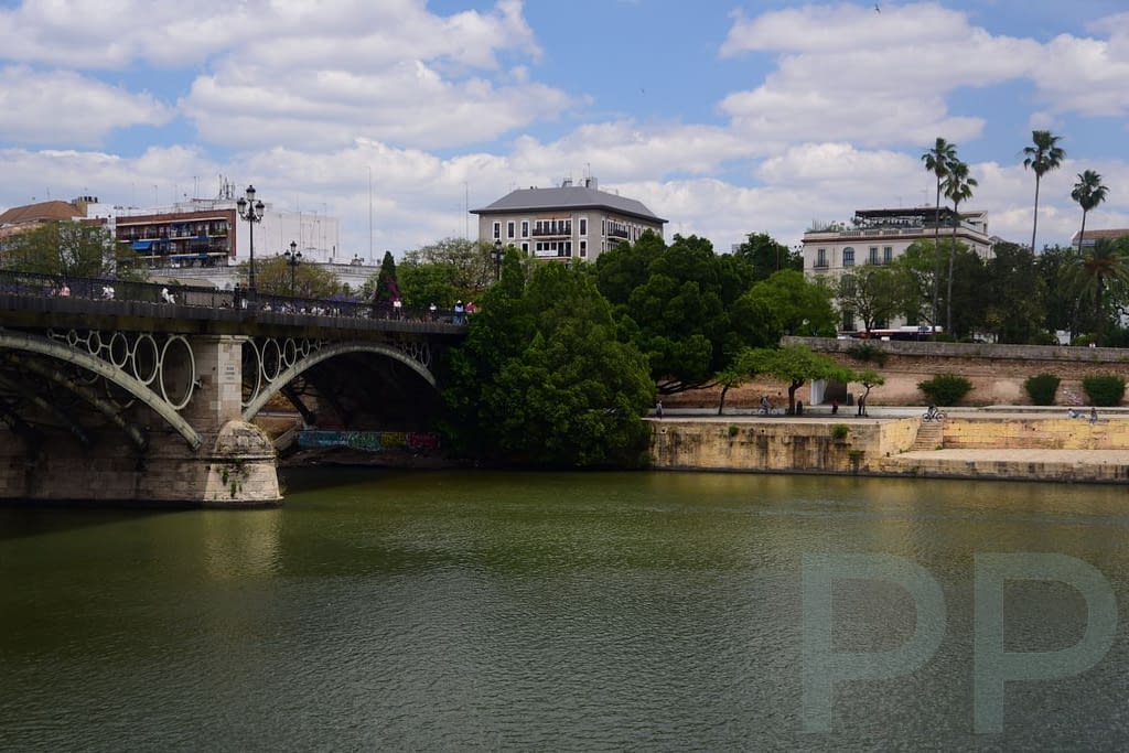 Puente de Isabel II bridge in Seville with river and skyline