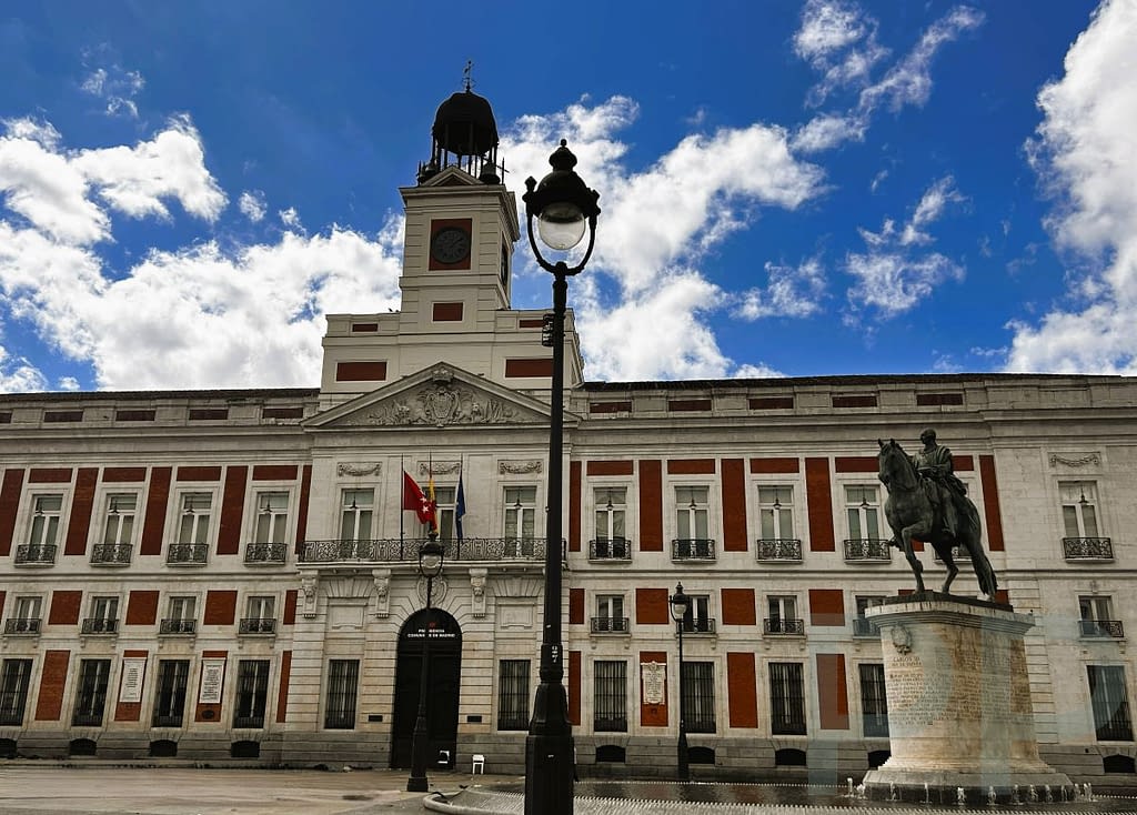 Plaza Mayor in Madrid with the central equestrian statue and people in the square.