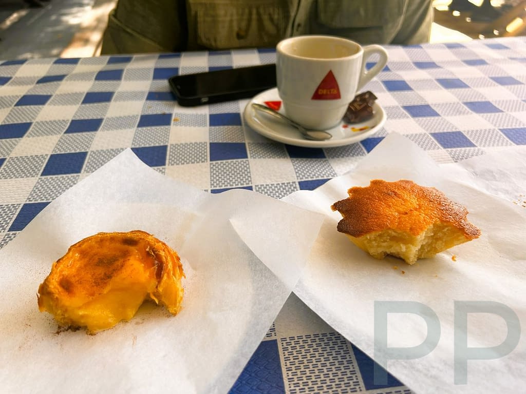 Pastel de nata and P&atilde;o de Rala pastries on parchment paper with a cup of espresso at The Bakery Lounge in &Eacute;vora.