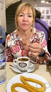 Plate of churros with thick hot chocolate for dipping in Madrid.