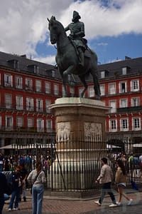 Equestrian statue of King Philip III in Plaza Mayor, Madrid, with the red surrounding façades.