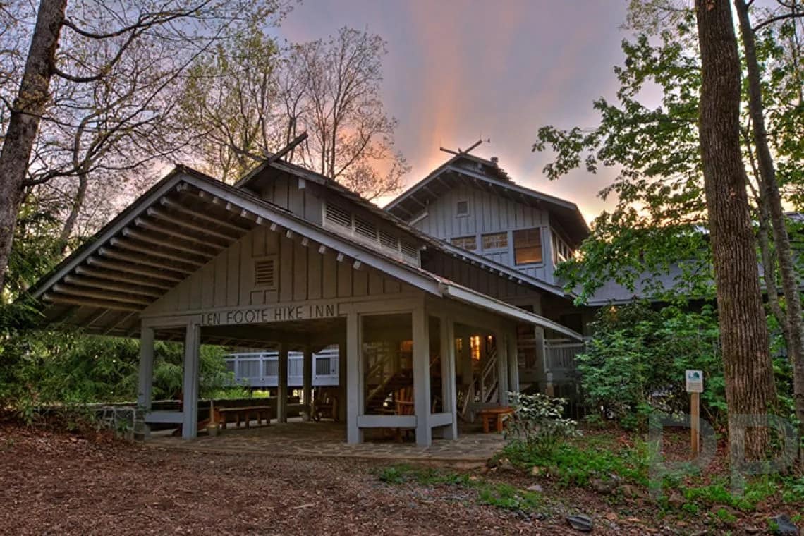 Exterior view of the Len Foote Hike Inn lodge surrounded by forest near Amicalola Falls in North Georgia.