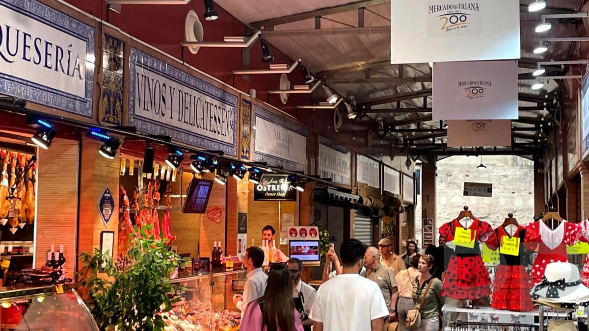 Interior of Mercado de Triana with food stalls and people