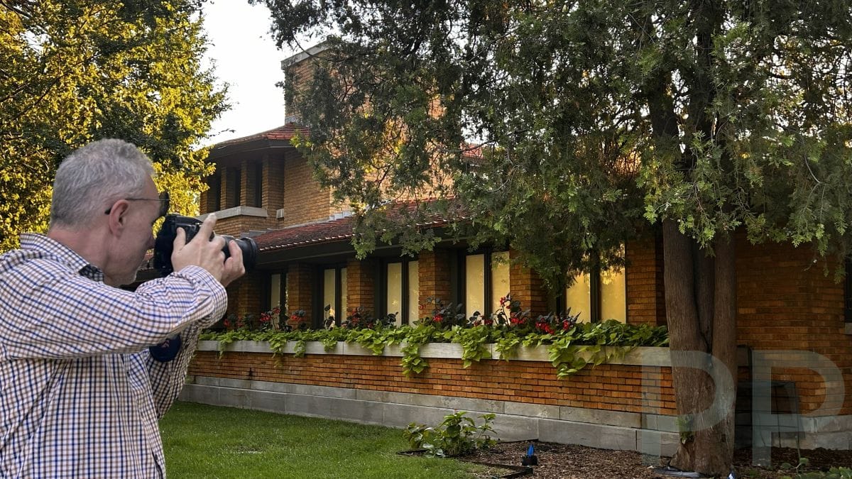 Photographer taking a picture of the exterior of the Frank Lloyd Wright Allen House in Wichita.