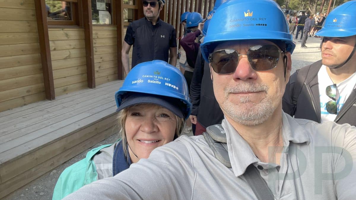 Visitors wearing helmets at the entrance gate to Caminito del Rey in Spain.