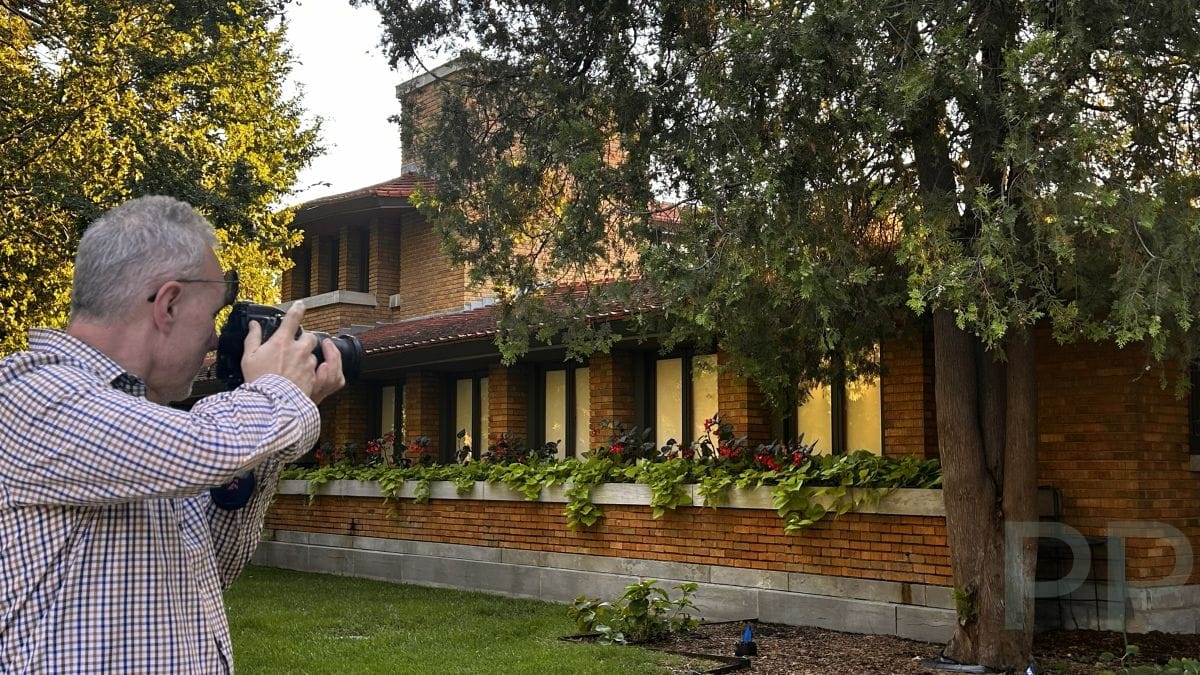 Photographer taking a picture of the exterior of the Frank Lloyd Wright Allen House in Wichita.