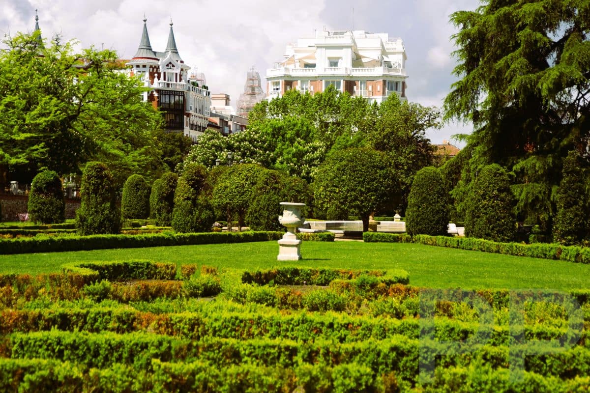 Gardens and tree-lined paths in Retiro Park in Madrid.