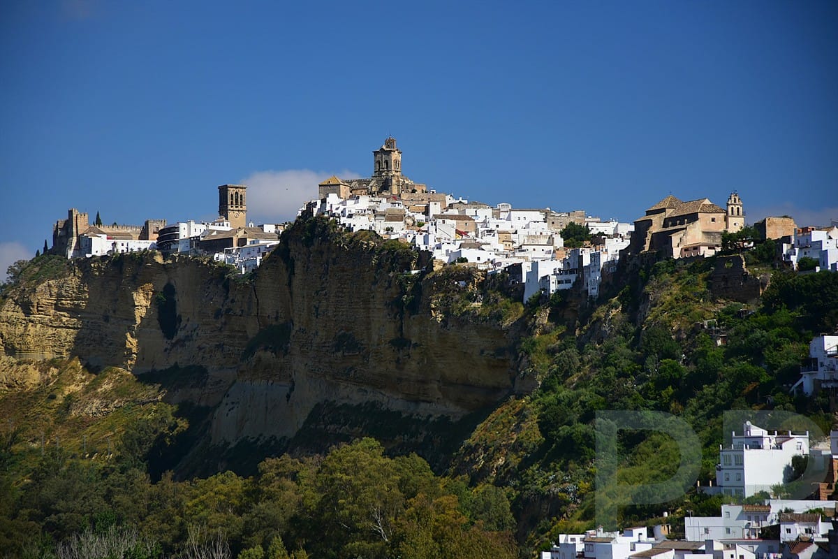Arcos de la Frontera perched on a cliff above the Guadalete River in Andalusia Spain