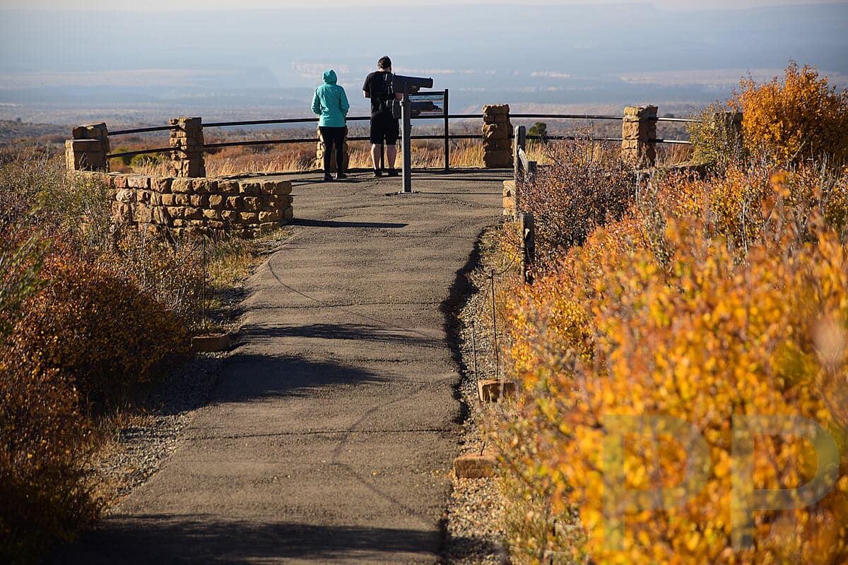 Visitors overlooking expansive views from Park Point in Mesa Verde National Park.