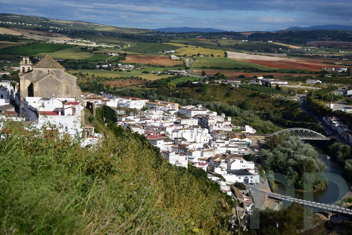 View overlooking the lower part of Arcos de la Frontera with the river and bridges.
