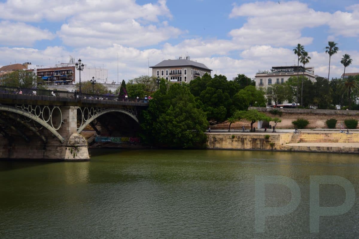 Puente de Isabel II bridge in Seville with river and skyline