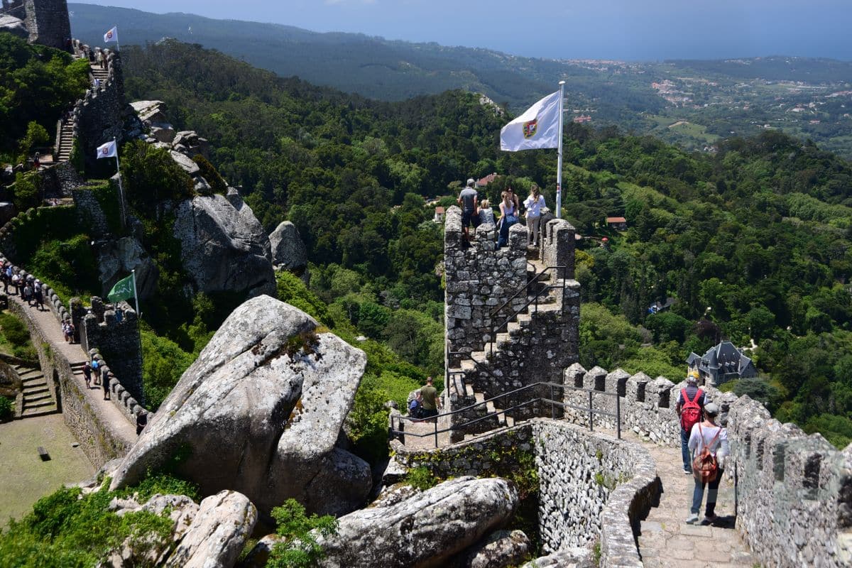 Colorful palace architecture in Sintra Portugal surrounded by greenery.
