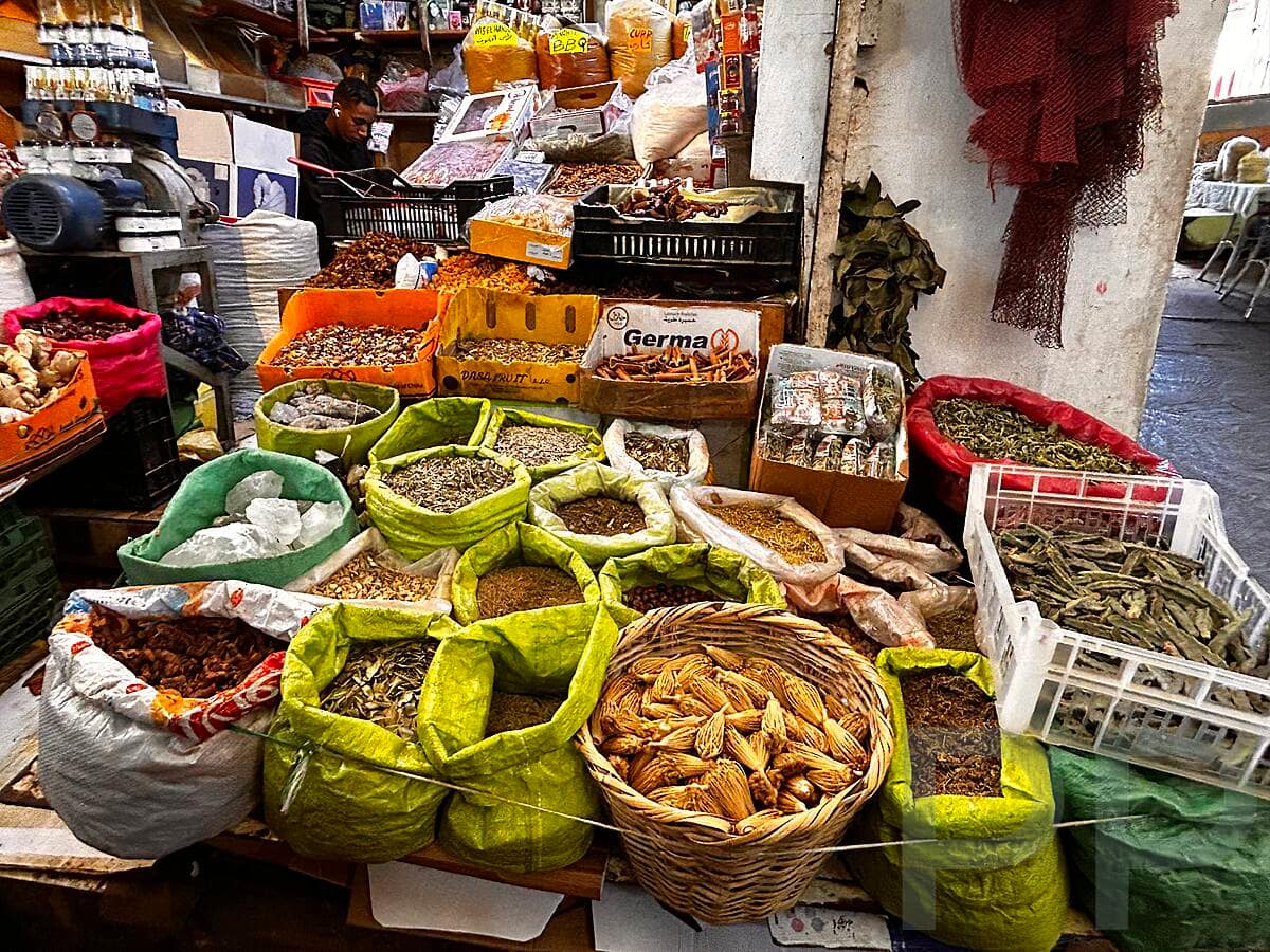 Colorful spices and goods displayed in a Tangier market.