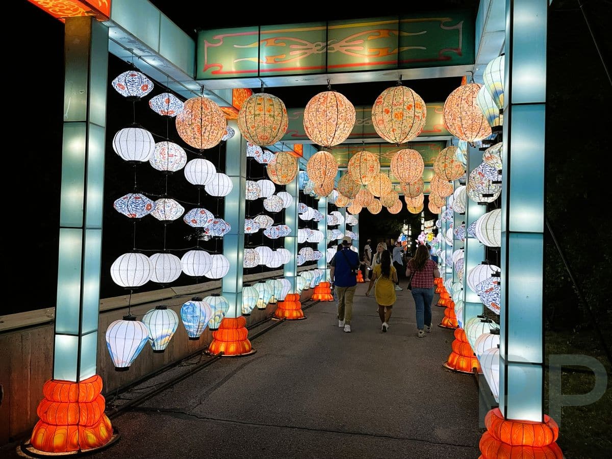 Colorful lantern archway featuring butterflies, clouds, and mountains at the Sedgwick County Zoo.