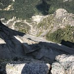 Peeking over the edge of Half Dome into Yosmite Valley