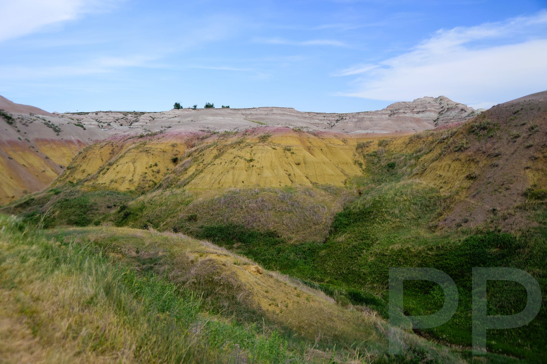 Rolling yellow and red mounds of sediment at Yellow Mounds Overlook in Badlands National Park.