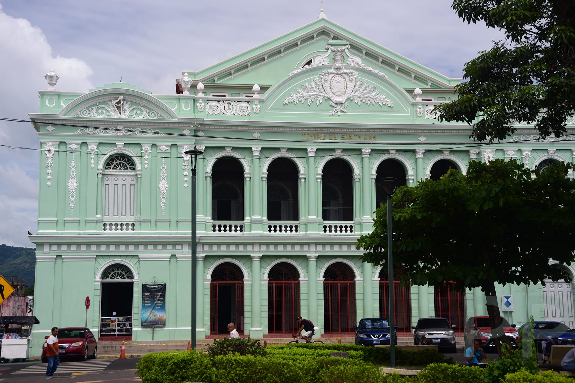 Exterior of the historic Teatro de Santa Ana with ornate mint-green fa&ccedil;ade and arched windows in Santa Ana, El Salvador.
