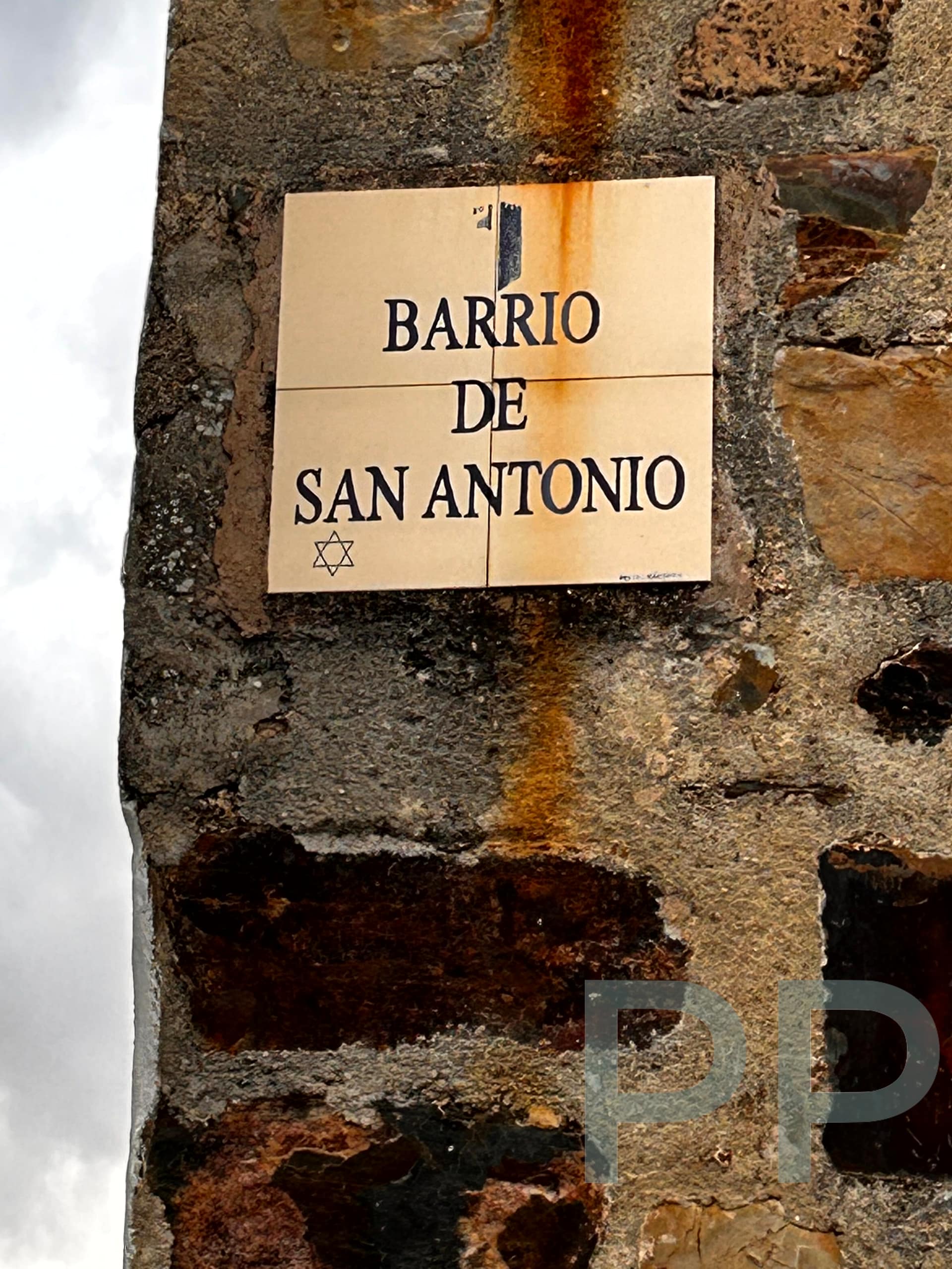 Sign marking the entrance to Barrio de San Antonio in C&aacute;ceres, featuring a Star of David to signify the historic Jewish Quarter.