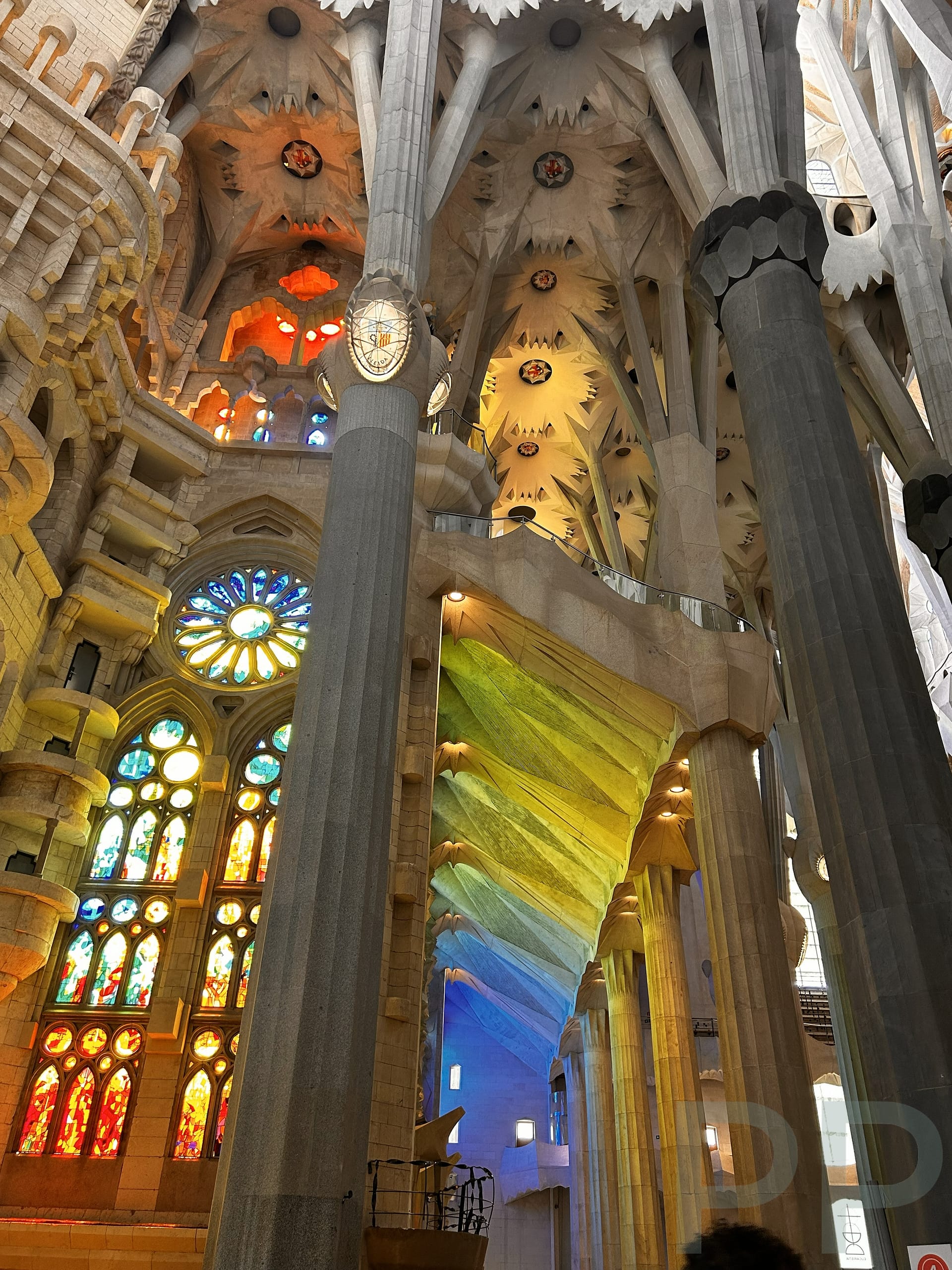 Interior of Sagrada Fam&iacute;lia showing columns and stained glass light